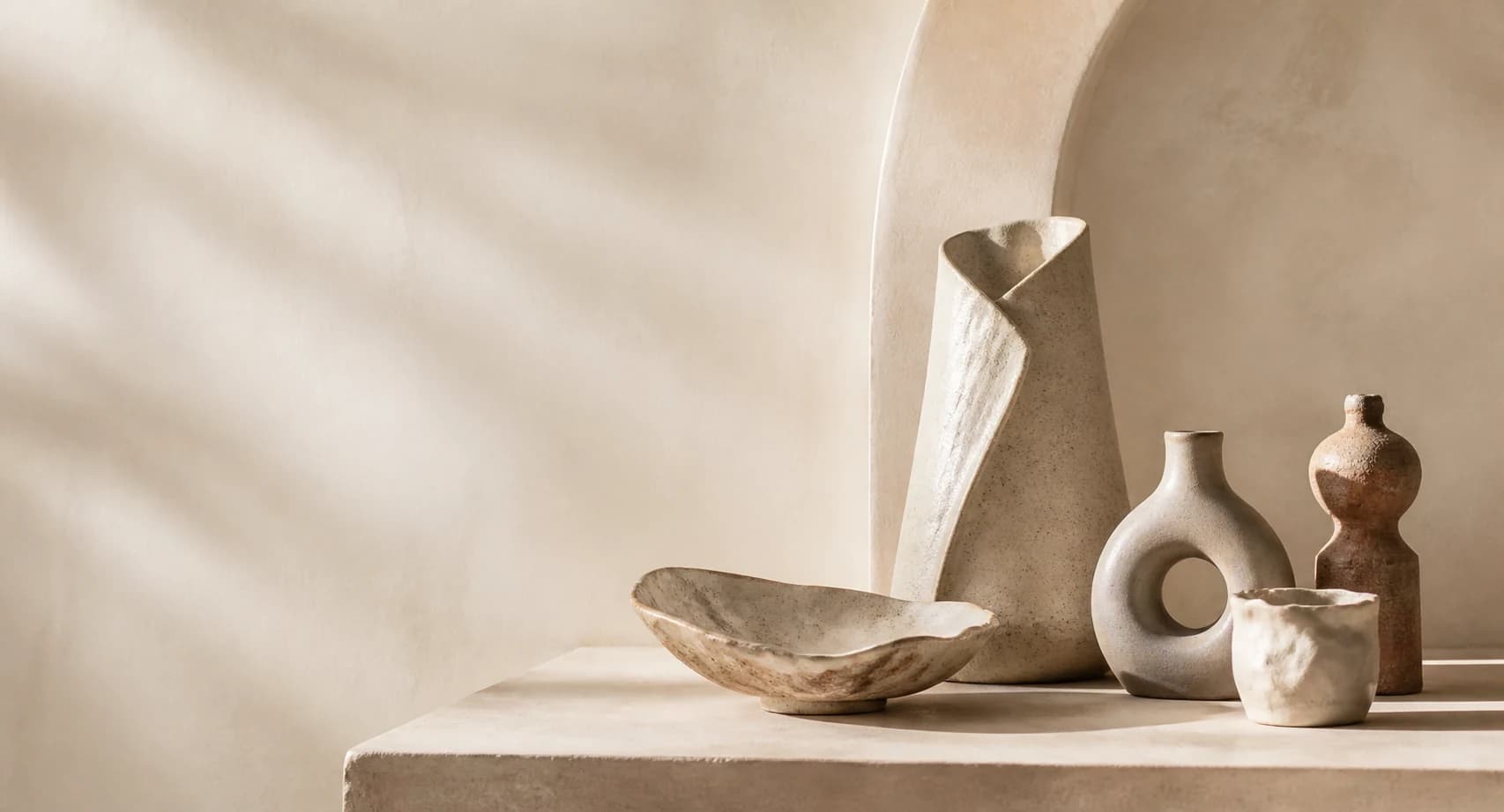 Bespoke handmade pottery arranged in a warm studio